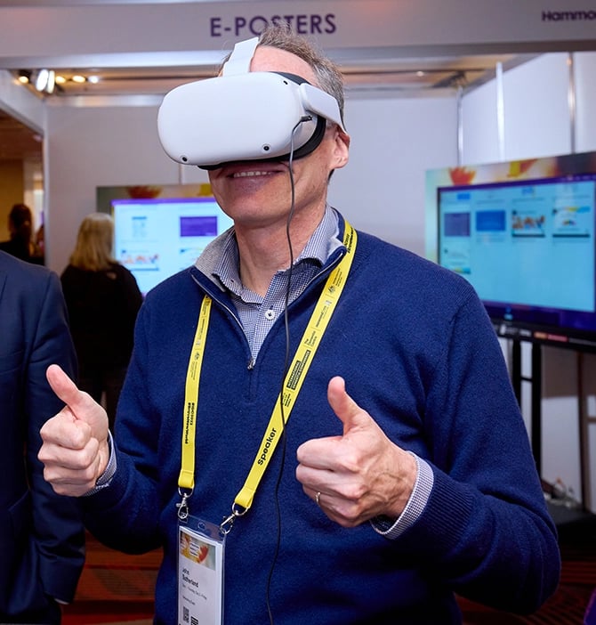 A man gives VR goggles two thumbs up at International Dementia Conference