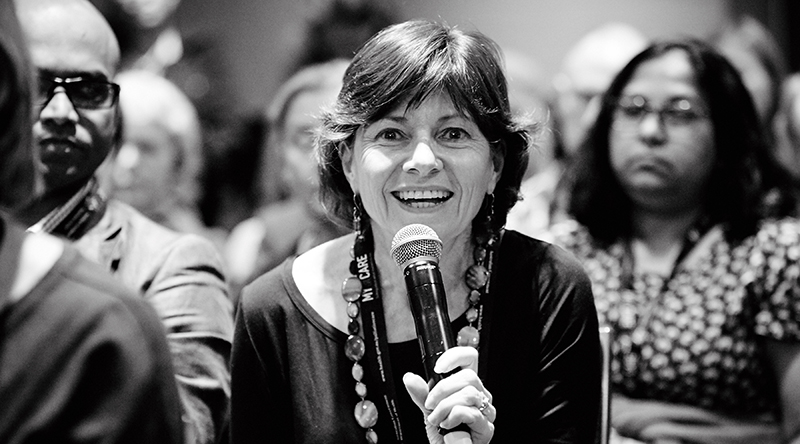 Smiling woman with microphone in crowd Smiling woman with microphone in crowd